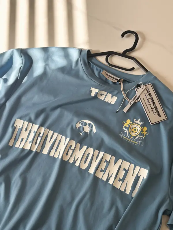 The Giving Movement The Giving Movement soccer tee