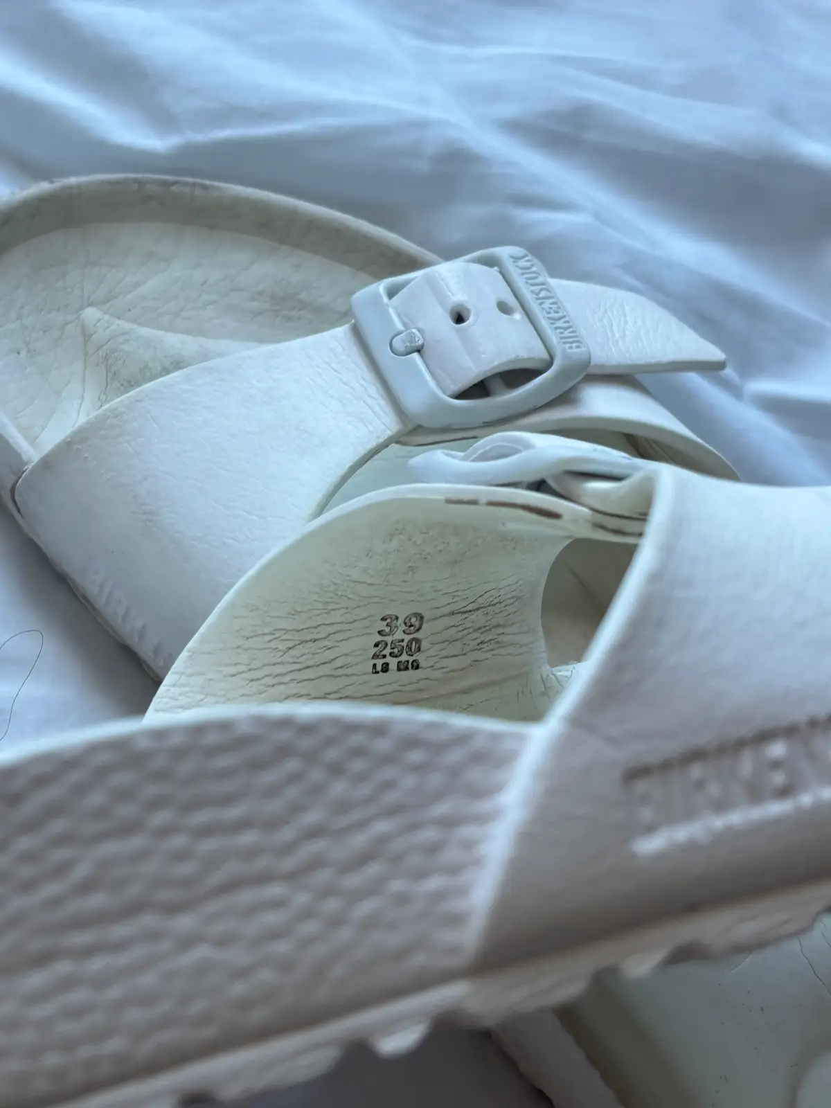 Birkenstock White Birkenstocks, slight tear by the strap