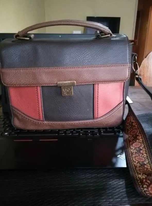 Ginger Mary Brown and tan Ginger Mary crossbody bag features a structured top handle and a metal clasp closure.