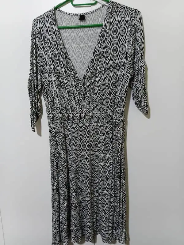 Woolworths Black and white geometric print dress is a wrap-style garment with a v-neckline and three-quarter sl