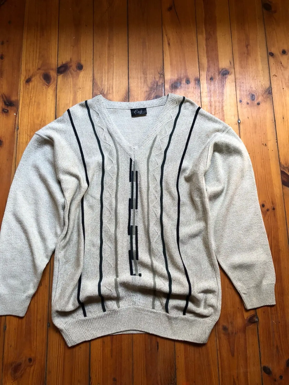 Cream V-Neck Sweater with Black Geometric Pattern