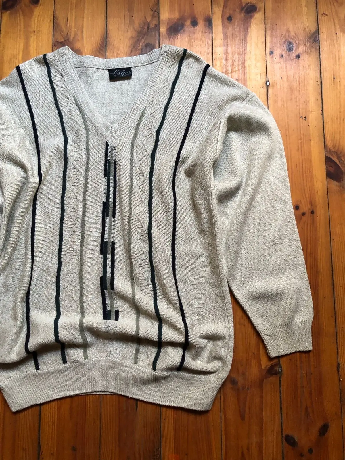 Cream V-Neck Sweater with Black Geometric Pattern