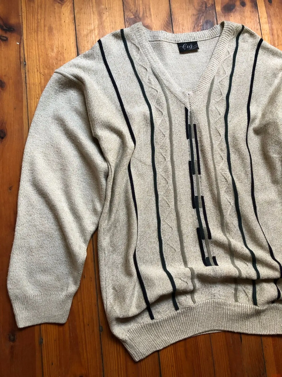 Cream V-Neck Sweater with Black Geometric Pattern