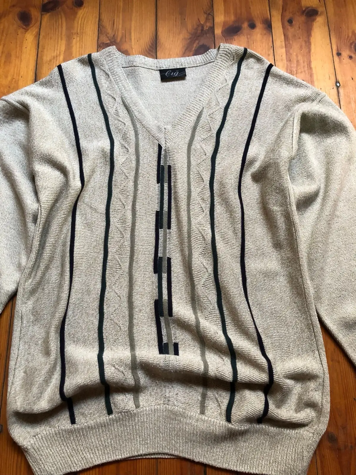 Cream V-Neck Sweater with Black Geometric Pattern