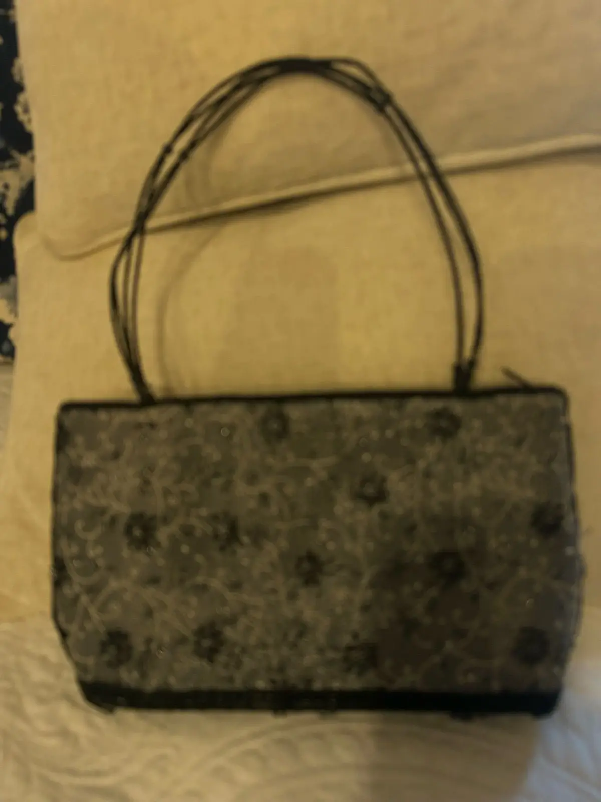Black patterned handbag with thin straps