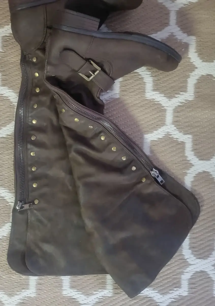 Knee-high riding boots in a dark brown faux suede/micro-suede finish. Features stud embellishments,