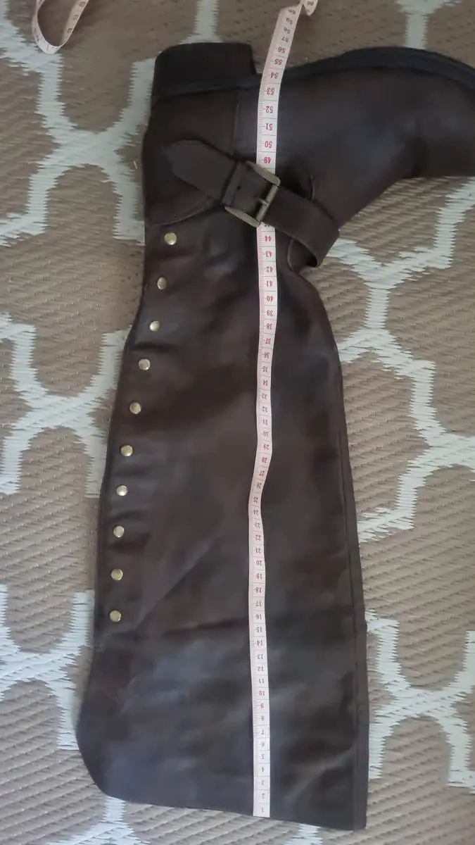 Knee-high riding boots in a dark brown faux suede/micro-suede finish. Features stud embellishments,