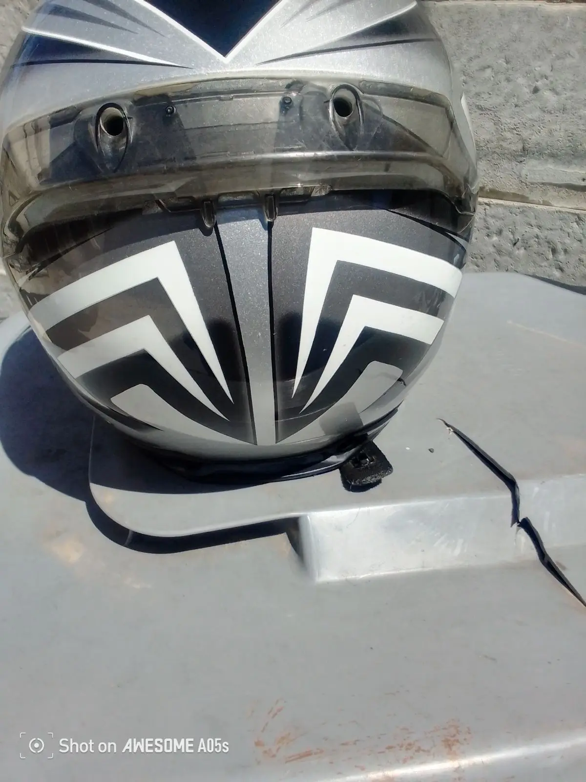 Silver and Black Motorcycle Helmet with Geometric Graphic
