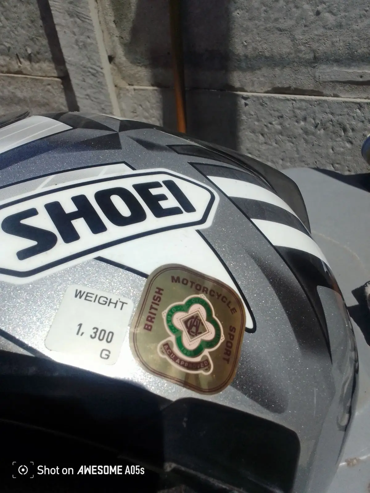 Silver and Black Motorcycle Helmet with Geometric Graphic